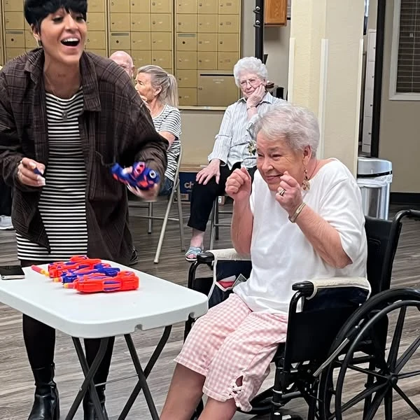 Whealdon Estates by Barclay House senior living community offering independent living in Baton Rouge, LA, excited resident smiling during fun community game