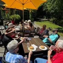 Avamere at Seaside senior living community offering independent living, assisted living, memory care, and respite care in Seaside, OR, residents dining outdoors and socializing