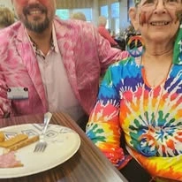 Wenatchee Senior Living by Cogir senior living community offering independent living, assisted living, and respite care in Wenatchee, WA, smiling resident in a tie dye shirt