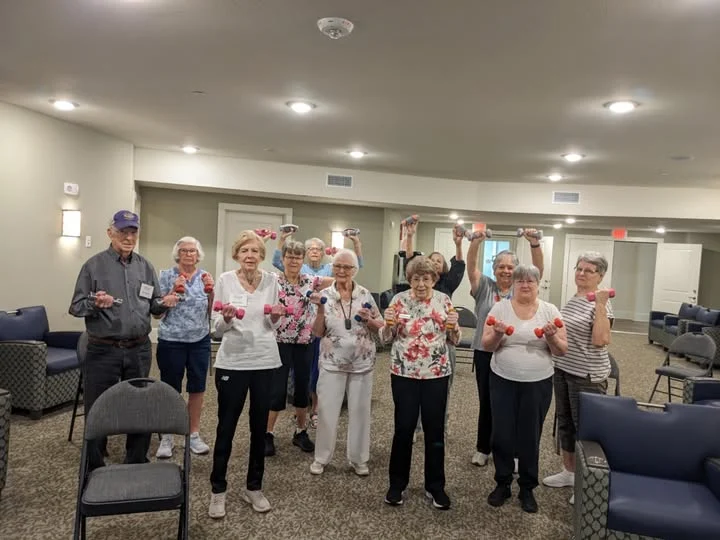 Wilshire Senior Living, independent living, assisted living, and memory care in Burleson, TX, residents staying active by lifting weights