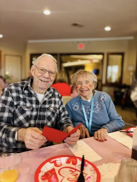 Residents at Kingsley Shores celebrating Valentine's Day with breakfast, gift bags, and live music