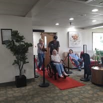 Grande Ronde Retirement Residence Senior Living in La Grande, Oregon resident in a wheelchair wheeling in on a red carpet
