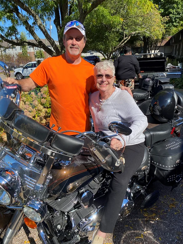American House Stone senior living community offering independent living and respite care in Rochester Hills, MI, smiling resident as she sits on a motorcycle