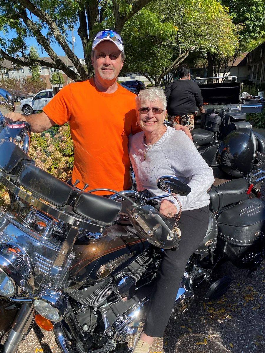 American House Stone senior living community offering independent living and respite care in Rochester Hills, MI, smiling resident as she sits on a motorcycle