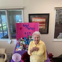 Providence Meadows Gracious Retirement Living Hawthorn Senior Independent Living in Charlotte, North Carolina resident holding a retail therapy shop