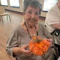 Linwood Estates Gracious Retirement Living Hawthorn Senior Independent Living in Lawrenceville, Georgia resident holding a pumpkin craft