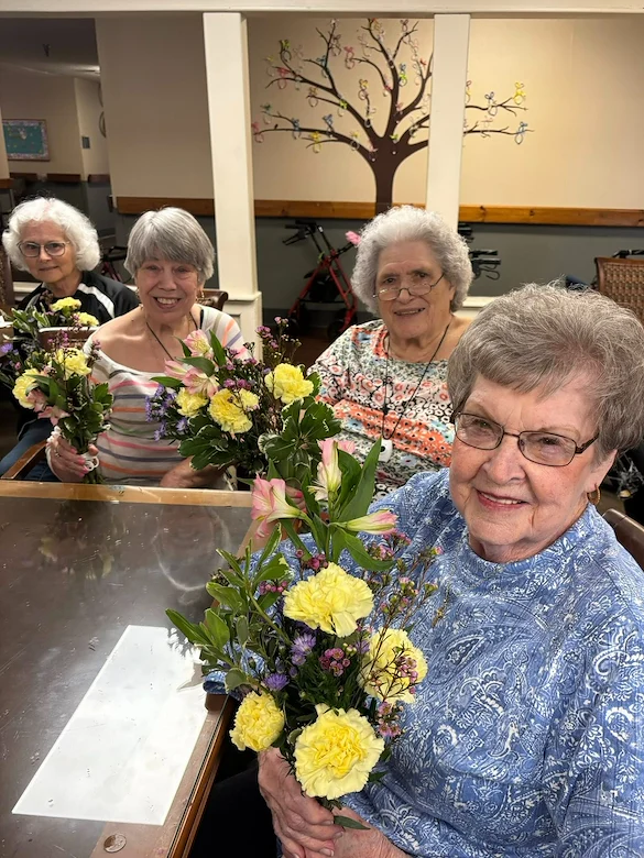 Charter Senior Living of Bowling Green residents smile with their floral arrangements