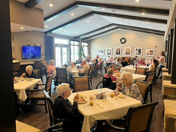 Park Vista Retirement Living - Camanche, IA, residents dining together and enjoying good company