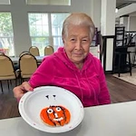 Orchard Heights Gracious Retirement Living Hawthorn Senior Independent Living in Clermont, Florida resident with decorated fall cookies