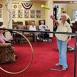 The Palms At La Quinta Gracious Retirement Living Hawthorn Senior Independent Living in La Quinta, California resident playing a pool noodle game