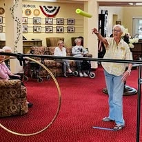 The Palms At La Quinta Gracious Retirement Living Hawthorn Senior Independent Living in La Quinta, California resident playing a pool noodle game