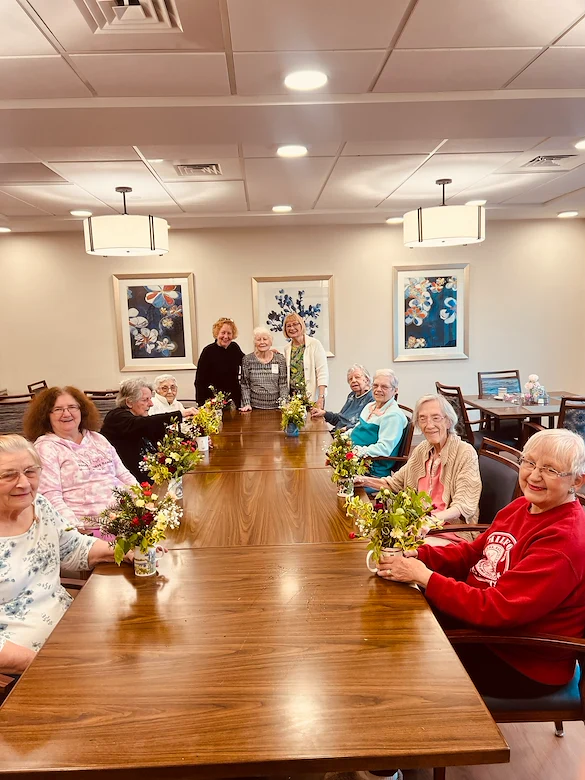 KindCare at Bristol, CT, residents smile with floral creations from activity
