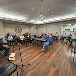 Seniors listening to guitar player