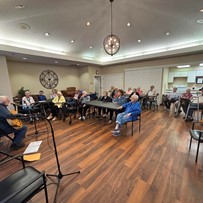 Seniors listening to guitar player