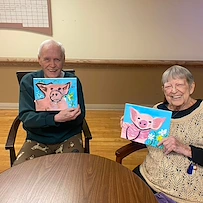 Prime Healthcare Senior Living – Fox Knoll Village in Aurora, IL, residents smile with their artwork
