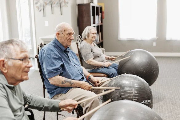 Residents participating in drumming activity