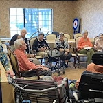 American House Stone senior living community offering independent living and respite care in Rochester Hills, MI, residents sitting in a circle and socializing