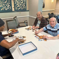 Charter Senior Living of Dedham in Dedham, MA, stimulating activity for residents - puzzles