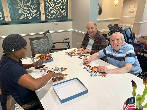 Charter Senior Living of Dedham in Dedham, MA, stimulating activity for residents - puzzles