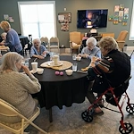 Orchard Ridge residents stuffing easter eggs and making decorative baskets to go along with it
