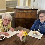 Pathfinder Senior Living in Fremont, NE, smiling residents enjoying a sweet treat