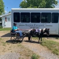 Alexis Estates Gracious Retirement Living Hawthorn Senior Living community in Allen, TX resident in a wheelchair being pulled by a horse