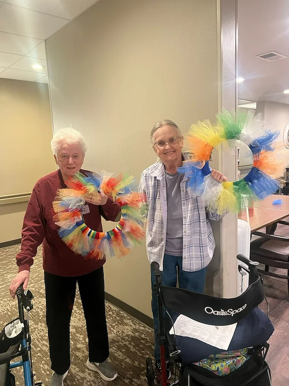 Park Vista Retirement Living - Camanche, IA, smiling residents with their craft creations