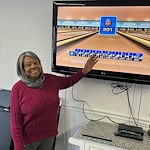 American House Farmington Hills, senior living community offering independent living, assisted living, memory care, and respite care in Farmington Hills, MI, resident having fun playing Wii Bowling