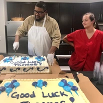 Cottonwood Estates Gracious Retirement Living Hawthorn Senior Independent Living in Alpharetta, Georgia chef staff member cutting a cake for residents