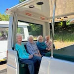 The Arbor at Avamere Court Assisted Senior Living in Keizer, Oregon residents in the back of a doorless bus