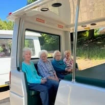 The Arbor at Avamere Court Assisted Senior Living in Keizer, Oregon residents in the back of a doorless bus