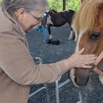 Stoneridge Gracious Retirement Living Hawthorn Senior Independent Living in Cary, North Carolina resident petting a horse