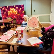 senior making a valentine at Serenades at Longwood