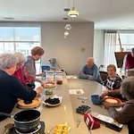 Ovation Heartwood Preserve Senior Living in Omaha, Nebraska residents gathered around a table