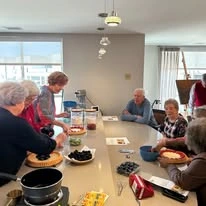 Ovation Heartwood Preserve Senior Living in Omaha, Nebraska residents gathered around a table