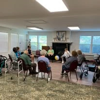 The Lodge at Wake Forest Gracious Retirement Living Hawthorn Senior Independent Living in Wake Forest, North Carolina residents playing a game