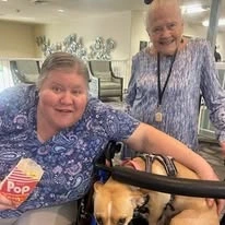 Albany Senior Living by Cogir, assisted living and respite care community in Albany, OR, residents enjoying a visit from a service dog