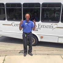 Cottonwood Estates Gracious Retirement Living Hawthorn Senior Independent Living in Alpharetta, Georgia staff member in front of transportation bus