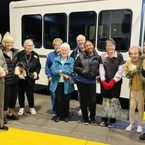 Sequoia Grove Gracious Retirement Living Hawthorn Senior Independent Living in Granite Bay, California residents standing in front of the transportation bus