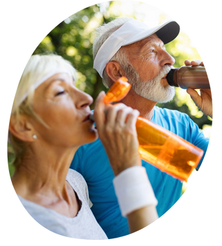 two seniors hydrating outside