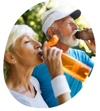 two seniors hydrating outside