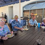The Barclay at Sarasota residents enjoying a 70s-style poolside happy hour