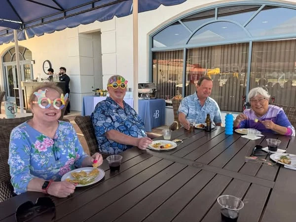The Barclay at Sarasota residents enjoying a 70s-style poolside happy hour
