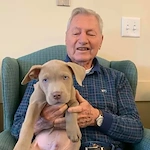 Willowbrook Place Senior Assisted Living Memory Care in Littleton, CO resident holding a puppy