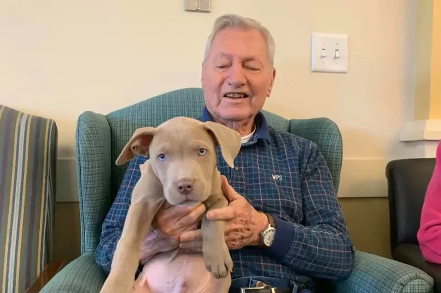 Willowbrook Place Senior Assisted Living Memory Care in Littleton, CO resident holding a puppy