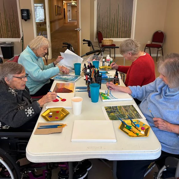 Residents of the Waters on 50th embracing their creativity and engaging in a painting class