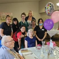 Gilman Grove Assisted Senior Living in Oregon City, Oregon resident with staff members at a birthday party