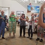 Kennedy Meadows Gracious Retirement Living Hawthorn Senior Independent Living in North Billerica, Massachusetts residents dancing at a Hawaiian themed party