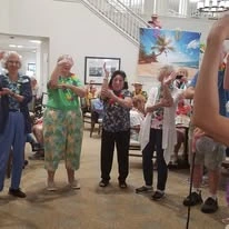 Kennedy Meadows Gracious Retirement Living Hawthorn Senior Independent Living in North Billerica, Massachusetts residents dancing at a Hawaiian themed party