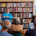 Piedmont Gardens Senior Living in Oakland, CA, residents engaged in a presentation in the library